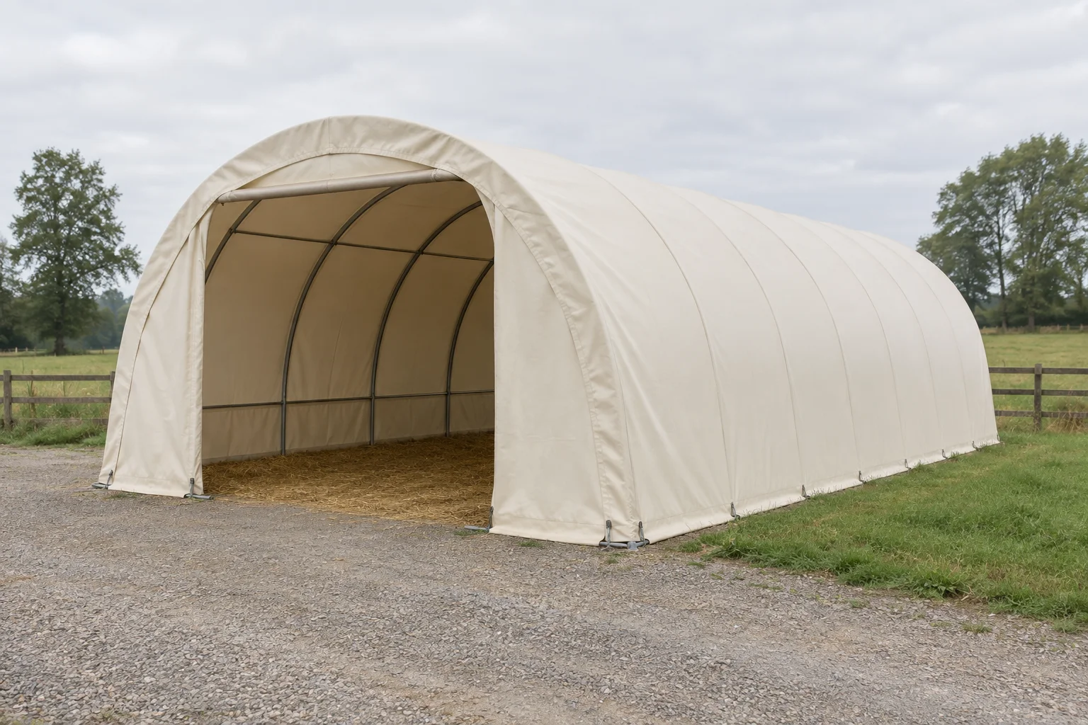 Illustration d’un abri tunnel clair doté d’un toit en arc, d’une entrée ouverte et d’un sol couvert de paille, près d’une prairie clôturée.